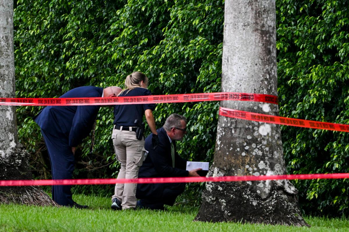 Law enforcement officials work at the crime scene outside the Trump International Golf Club in West Palm Beach, Florida, on September 16, 2024. (Chandan Kahnna/AFP via Getty Images)