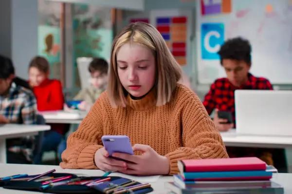 Student looking at phone in class(nimito/Shutterstock)