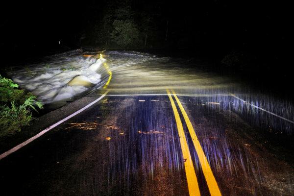 Flood waters wash over Guy Ford Road bridge on the Watauga River as Hurricane Helene approaches in the North Carolina mountains, in Sugar Grove, N.C., on Sept. 26, 2024. (Jonathan Drake/Reuters)