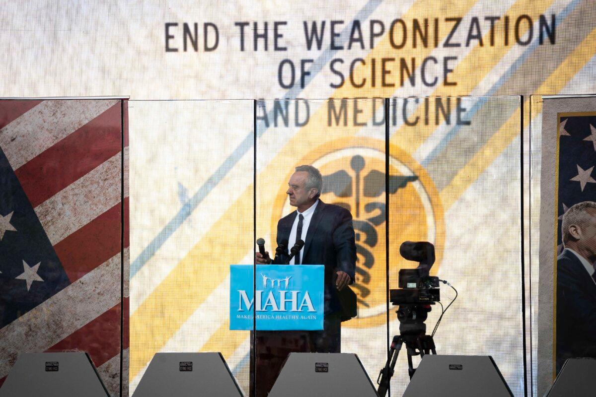 Robert F. Kennedy Jr. speaks behind a bulletproof glass during the Rescue the Republic rally in Washington, on Sept. 29, 2024. (Madalina Vasiliu/The Epoch Times)