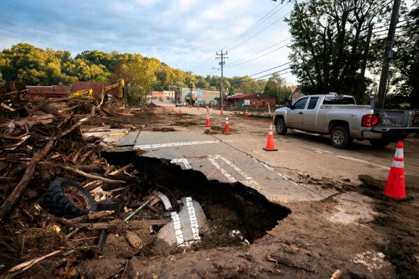 A motorist passes flood damage at a bridge across Mill Creek in the aftermath of Hurricane Helene in Old Fort, N.C., on Sept. 30, 2024. (Sean Rayford/Getty Images)