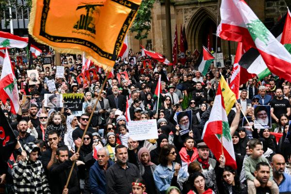 Hundreds of demonstrators hold flags and pictures of Hassan Nasrallah, late leader of the Lebanese group Hezbollah, at a protest rally in the central business district of Sydney, Australia, on Sept. 29, 2024. (Saeed Khan/AFP via Getty Images)