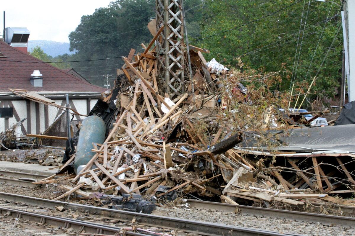 Debris reached an estimated 15 feet around a railway signal pylon in Biltmore Village, Asheville, N.C. Photo taken on Oct. 3, 2024. (Richard Moore/The Epoch Times)