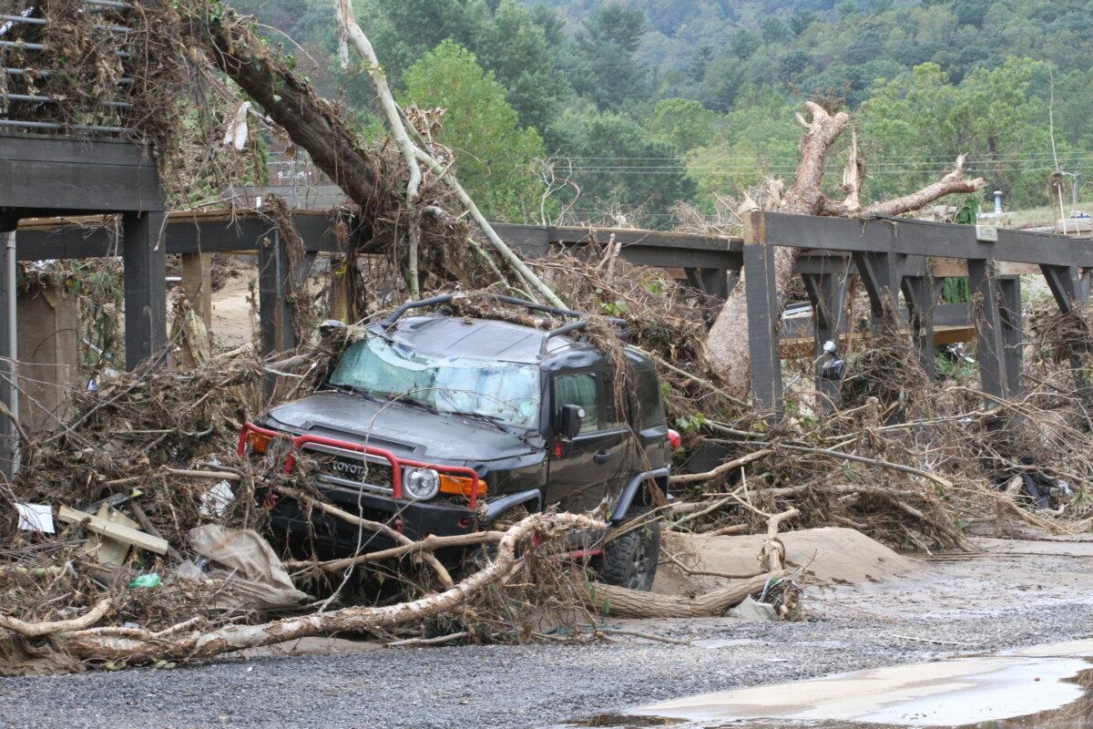 A wrecked car near the Swannanoa River, N.C., in the aftermath of Hurricane Helene on Oct. 3, 2024. (Richard Moore/The Epoch Times)