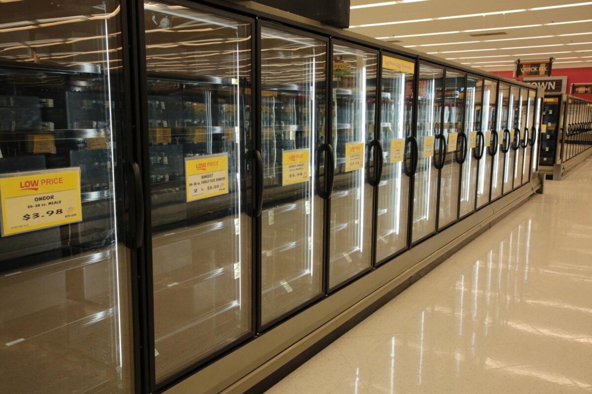 Empty chiller units at the Ingles supermarket in Swannanoa, N.C., on Oct. 2, 2024. Power was cut by the floodwaters and only nonperishable goods lasted in the heat. (Richard Moore/The Epoch Times)