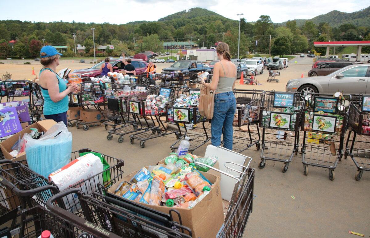 Volunteers help flood-affected residents in Swannanoa, N.C., on Oct. 2, 2024. (Richard Moore/The Epoch Times)