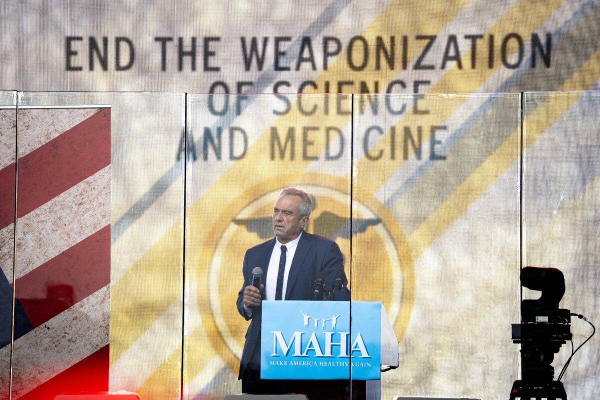 Robert F. Kennedy Jr. speaks behind a bulletproof glass during the Rescue the Republic rally in Washington on Sept. 29, 2024.(Madalina Vasiliu/The Epoch Times)