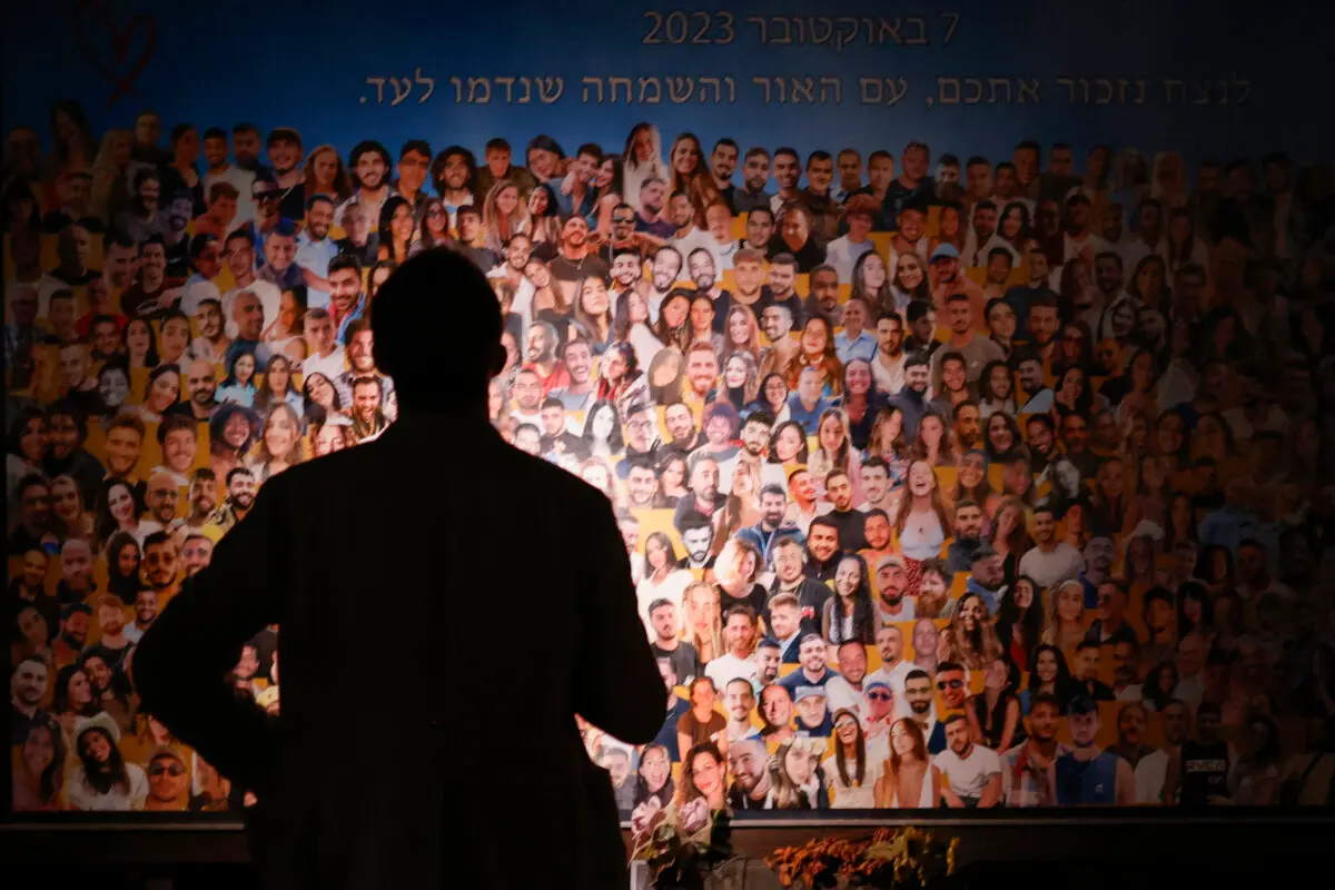 A person views a collage as relatives and supporters of Israeli hostages, taken during the Oct. 7, 2023, Hamas attack, attend the Nova memorial near Kibbutz Reim in southern Israel, the site of the Nova music festival attacked by terrorists, during the first anniversary of the attacks on Oct. 7, 2024. (John Wessels/AFP via Getty Images)