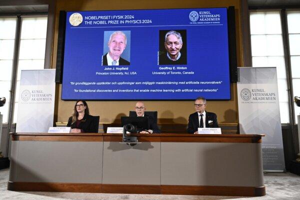 John Hopfield and Geoffrey Hinton, seen in picture, are awarded this year's Nobel Prize in Physics, which is announced at a press conference by Hans Ellergren (C), ermanent secretary at the Swedish Academy of Sciences in Stockholm on Oct. 8, 2024. (Christine Olsson/TT News Agency via AP)
