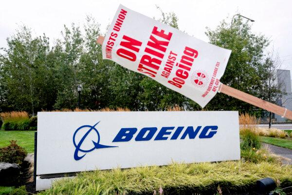 A strike sign hangs from a post near a Boeing sign as Boeing factory workers and supporters gather on a picket line in Renton, Washington, on Sept. 15, 2024. (David Ryder/Reuters)