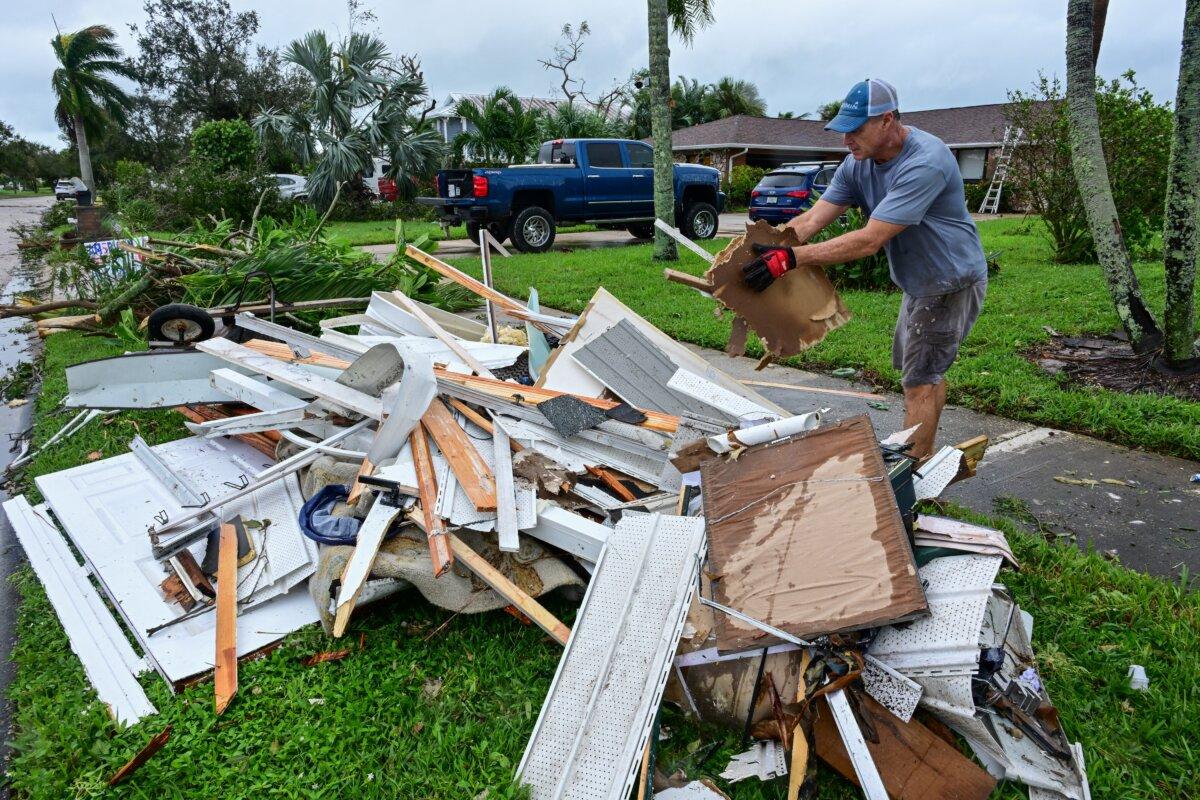 A man collects debris caused by the destruction of the tornado's path in Cocoa Beach, Fla.,on Oct. 10, 2024. (Giorgio Viera/AFP via Getty Images)