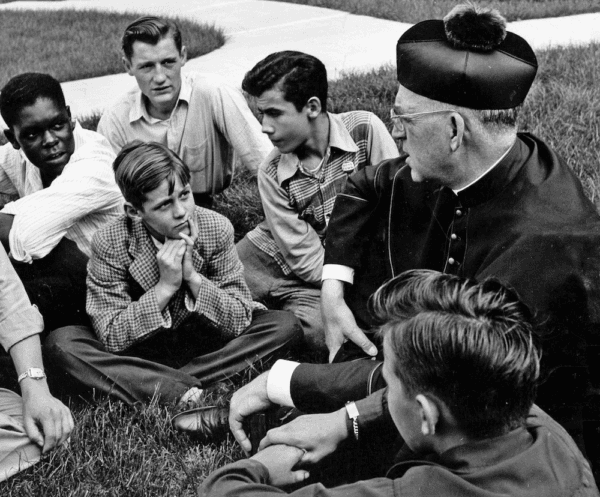 Father Edward Flanagan, the Irish-born priest who founded Boys Town in Nebraska, talks with a group of boys in "Heart of a Servant: The Father Flanagan Story." (Spirit Juice Studios)