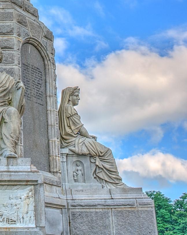 A profile of Education. Below her on the side panel is Youth, showing a child holding hands with his mother. (<a href="https://commons.wikimedia.org/wiki/User:Dsdugan">Dsdugan</a>/<a href="https://en.wikipedia.org/wiki/National_Monument_to_the_Forefathers#/media/File:15_23_0510_monument_law.jpg">CC BY-SA 4.0</a>)