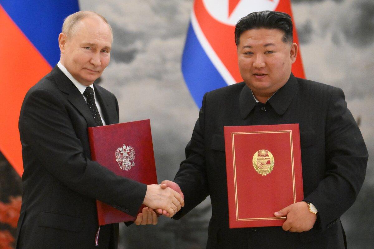 Russian President Vladimir Putin (L) shakes hands with North Korean leader Kim Jong Un (R) after a signing ceremony following their bilateral talks at Kumsusan state residence in Pyongyang, North Korea, on June 19, 2024. (Kristina Kormilitsyna / POOL /AFP via Getty Images)