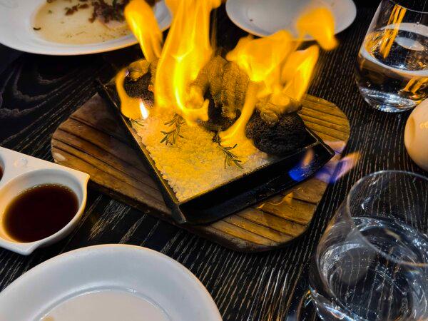 A5 Wagyu beef is set alight at the table by the waiter before being served with sauces. (Alan Behr/TNS)