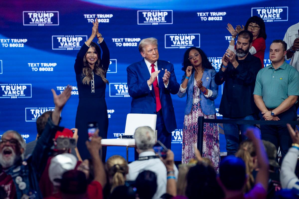 South Dakota Gov. Kristi Noem (L) and Republican presidential candidate, former President Donald J. Trump (C) during a town hall at the Greater Philadelphia Expo Center & Fairgrounds in Oaks, Pa., on Oct. 14, 2024. (Madalina Vasiliu/The Epoch Times)