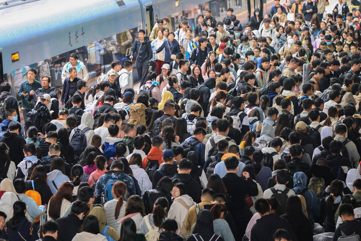 People arrive at Nanjing railway station after the National Day holidays in Nanjing, in eastern China's Jiangsu province, on Oct. 7, 2024. (STRINGER/AFP via Getty Images)