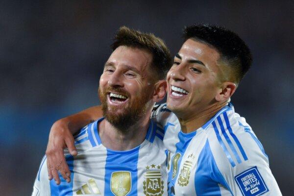 Argentina's Lionel Messi, (L), celebrates with teammate Thiago Almada after scoring his side's fifth goal against Bolivia during a World Cup 2026 qualifying soccer match at Monumental stadium in Buenos Aires, Argentina, on Oct. 15, 2024. (Gustavo Garello/AP Photo)