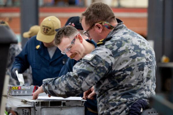 United States Navy and Royal Australian Navy sailors work together during the Submarine Tender Maintenance Period at Fleet Support Unit-West, HMAS Stirling in Western Australia. Photo: LSIS Rikki-Lea Phillips. Courtesy Australian Defence Force.