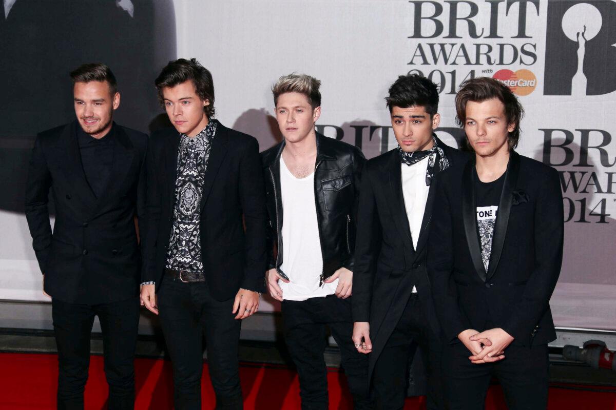 (L–R) British band One Direction's Liam Payne, Harry Styles, Niall Horan, Zayn Malik, and Louis Tomlinson arrive at the BRIT Awards 2014 at the O2 Arena in London on Feb. 19, 2014. (Joel Ryan/Invision/AP)