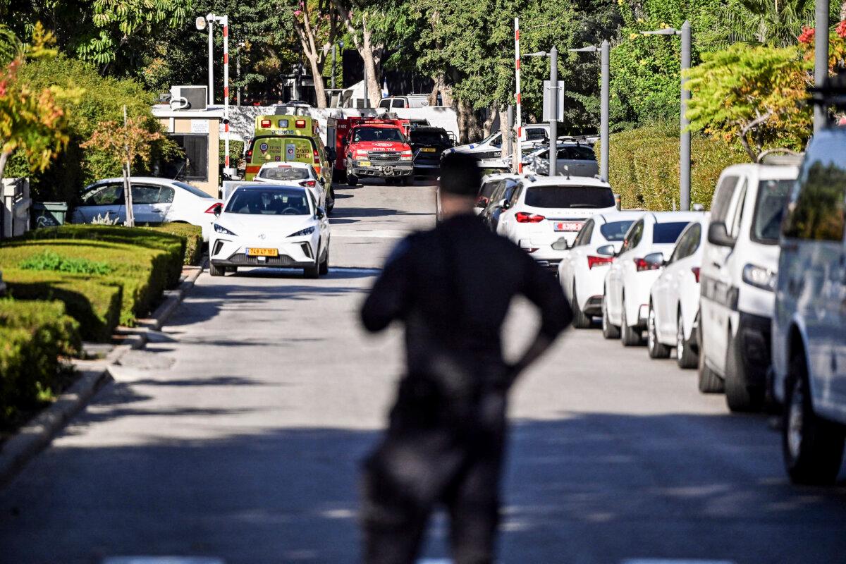 A member of Israeli security stands at the entrance to a street following a drone attack from Lebanon toward Israel amid ongoing hostilities between Hezbollah and Israel, in Caesarea, Israel, on Oct. 19, 2024. (Rami Shlush/Reuters)