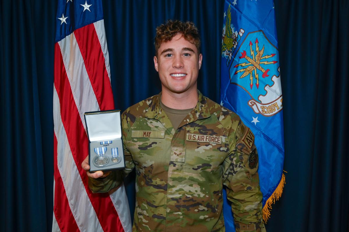 U.S. Air Force Airman 1st Class Troy May holds his Air Force Achievement Medal at Joint Base Lewis-McChord, Washington. (U.S. Air Force photo by Airman 1st Class Benjamin Riddle)
