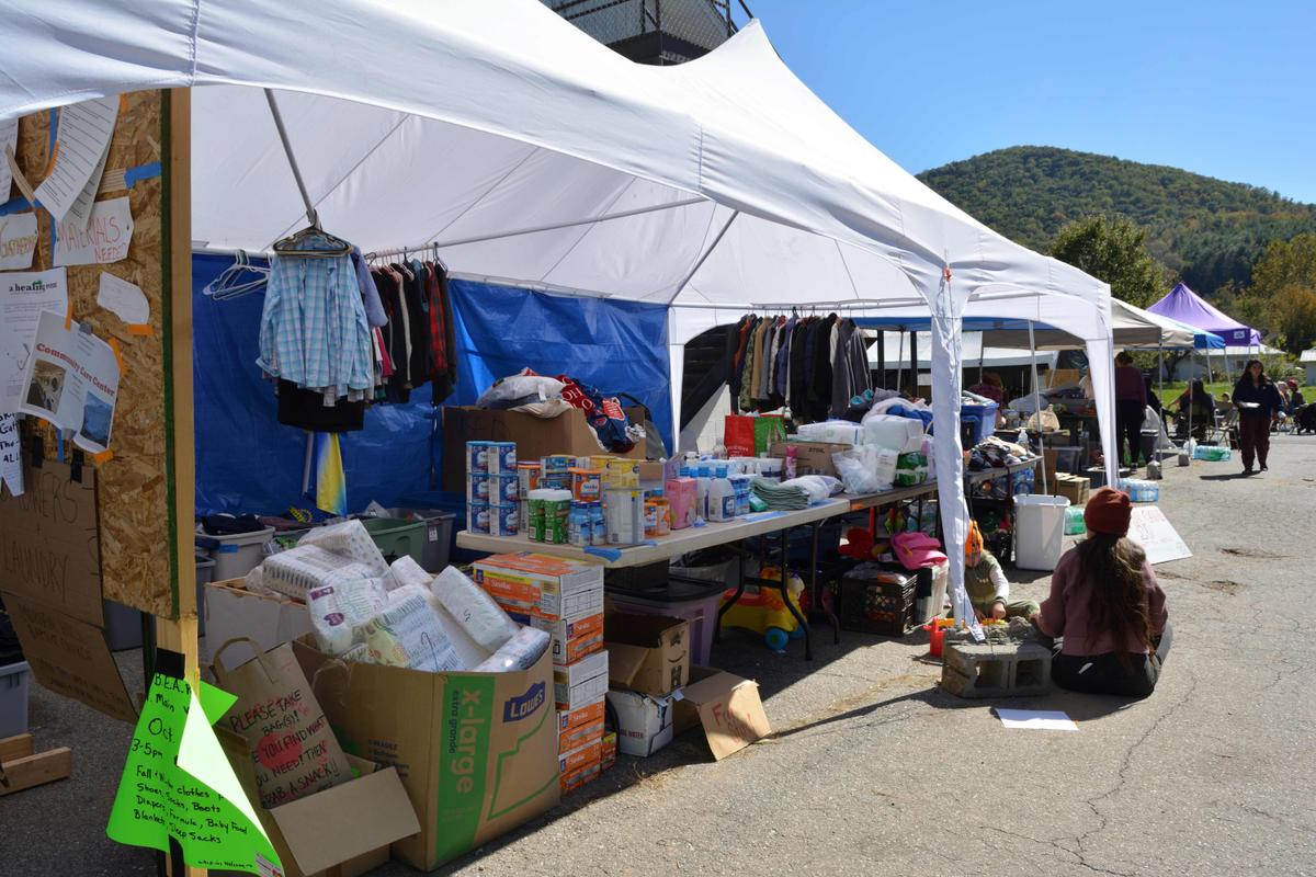 Pop-up canopies in Barnardsville, N.C. offer food, clothing, and other necessities to imperiled residents. (Deena Bouknight)