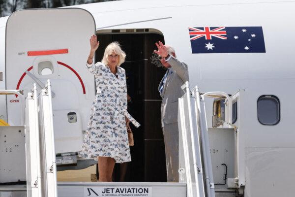 Britain's King Charles III and Queen Camilla wave as they depart from Sydney Airport in Sydney on Oct. 23, 2024. (David Gray/AFP via Getty Images)