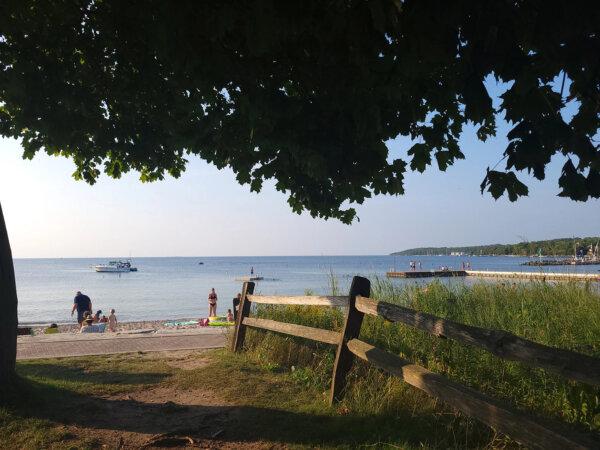 Beachgoers catch the last of the sun's rays in Sister Bay, Wis. (Lacey Pfalz/TravelPulse/TNS)
