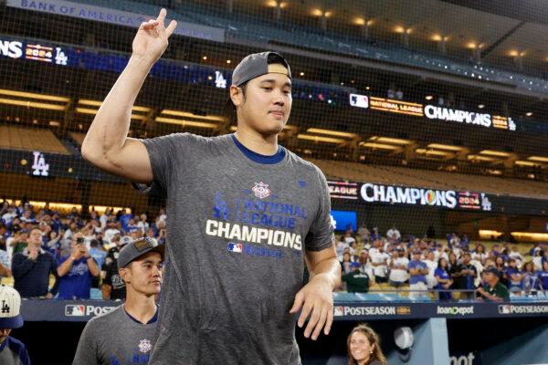 Shohei Ohtani #17 of the Los Angeles Dodgers walks onto the field from the locker room celebration after the Dodgers defeated the New York Mets to win Game Six of the National League Championship Series at Dodger Stadium in Los Angeles, Calif., on Oct. 20, 2024. (Kevork Djansezian/Getty Images)