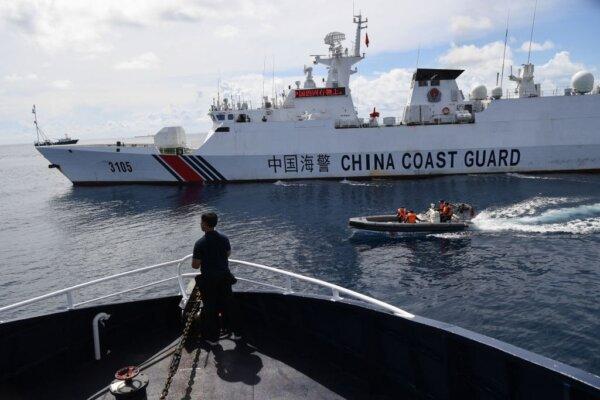 This photo taken on Sept. 22, 2023, shows a Chinese Coast Guard ship (R) blocking a Philippine Bureau of Fisheries and Aquatic Resources (BFAR) ship as it neared the Chinese-controlled Scarborough Shoal in the disputed South China Sea. (TED ALJIBE/AFP via Getty Images)