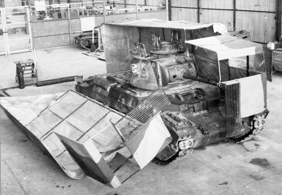 "Sunshield" split cover, one half on, one half off a tank in the workshops at Middle East Command Camouflage Development and Training Centre, Helwan, Egypt, 1941. The original concept was from Gen. Wavell, head of the British forces in the Middle East. (Public Domain)