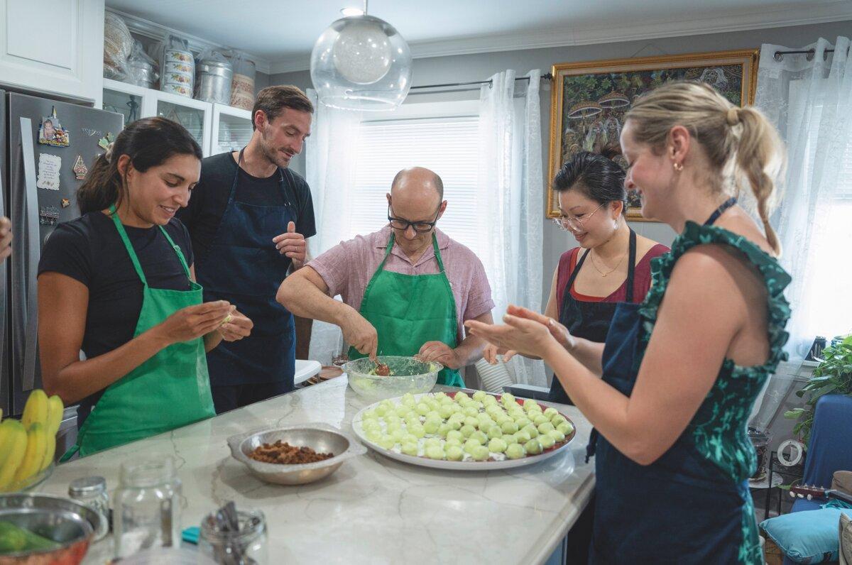 Students assemble klepon, sweet rice cakes flavored with pandan and stuffed with coconut sugar. (Samira Bouaou for American Essence)