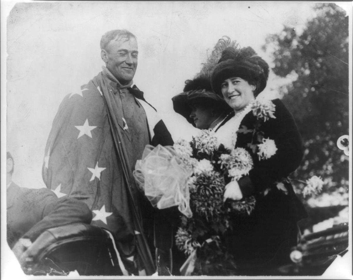 Rogers draped with U.S. flag and flowers upon arrival in Pasadena, Calif., 1911. Library of Congress. (Public Domain)