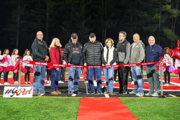 (L–R) Port Jervis Councilman at Large Mike Hockenbury, Doreen and Ron Semerano, Bob and Betty Corvino, state Sen. James Skoufis, Port Jervis Mayor Dominic Cicalese, and Port Jervis School District Superintendent John Bell at the ribbon-cutting ceremony at Glennette Field in Port Jervis, N.Y., on Oct. 25, 2024. (Cara Ding/The Epoch Times)