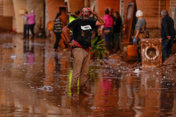 A man reacts in front of houses affected by floods in Utiel, Spain, on Oct. 30, 2024. (Manu Fernandez/AP Photo)