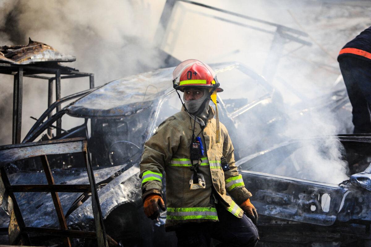 A firefighter stands amid the smoldering debris at the site of overnight Israeli airstrikes that targeted the neighborhood of Kafaat in Beirut's southern suburbs on Nov. 1, 2024. (AFP via Getty Images)