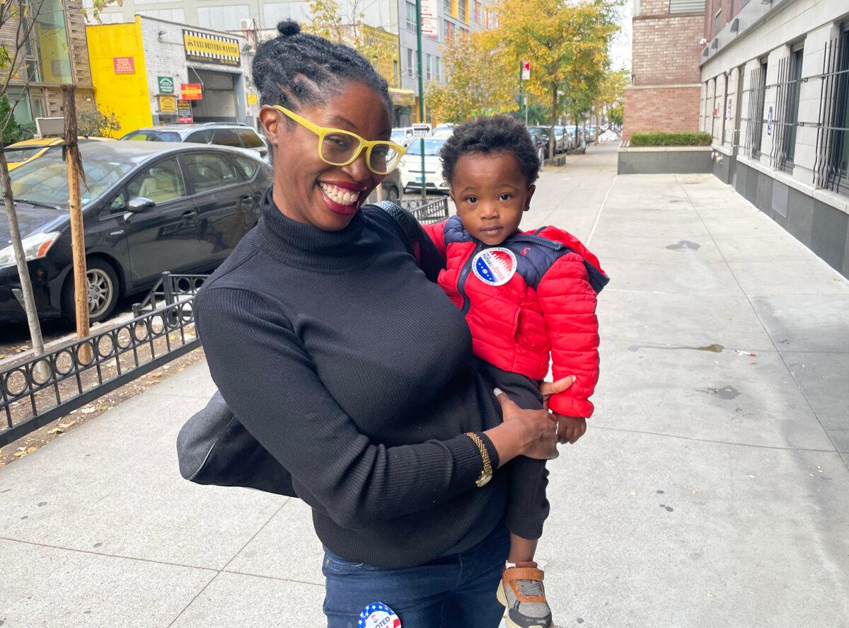 Kariyam Reid with her son Champion after voting in New York City on Nov. 5, 2024. Reid says she voted for Kamala Harris because "I feel like it was time for a change. To have a woman in the presidency would be a really good change." (Richard Moore/The Epoch Times)