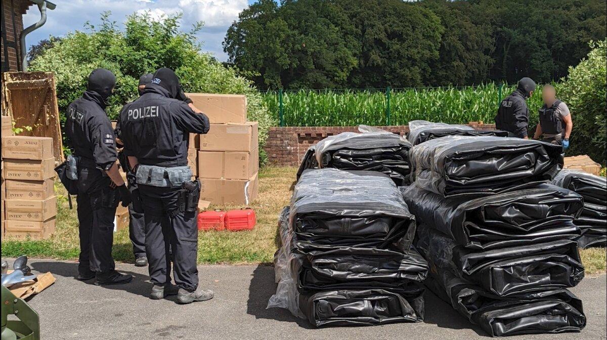 German police with some of the people traffickers' inflatable boats that were seized in Osnabruck, Germany, on July 5, 2022. (UK National Crime Agency)
