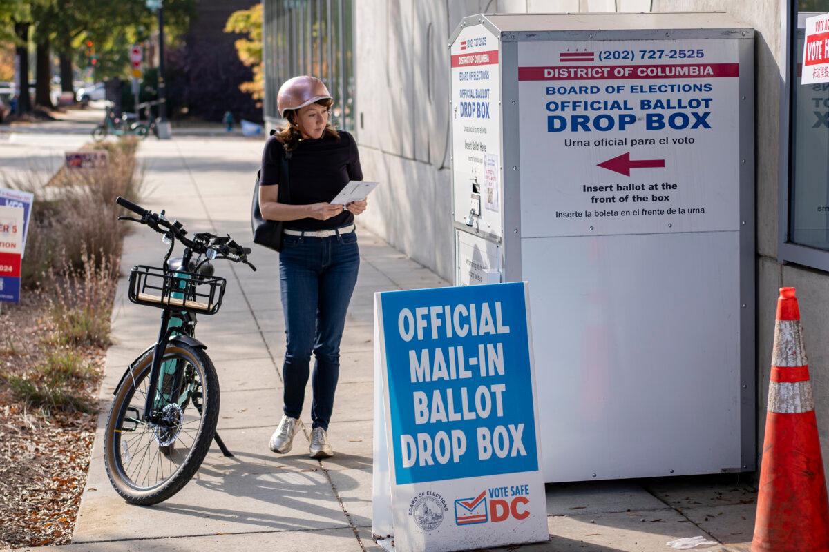 A woman casts her mail-in vote at an official ballot drop box in Washington on Nov. 5, 2024. (Madalina Vasiliu/The Epoch Times)
