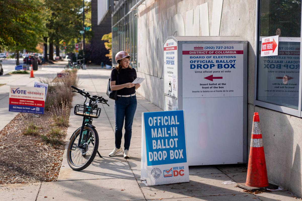 A woman casts her mail-in vote at an official ballot drop box in Washington on Nov. 5, 2024. (Madalina Vasiliu/The Epoch Times)