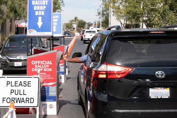 A driver drops off a mail ballot on Nov 5, 2024 to a mail ballot drop box outside of the San Diego County Registrar of Voters. (Jane Yang/The Epoch Times)