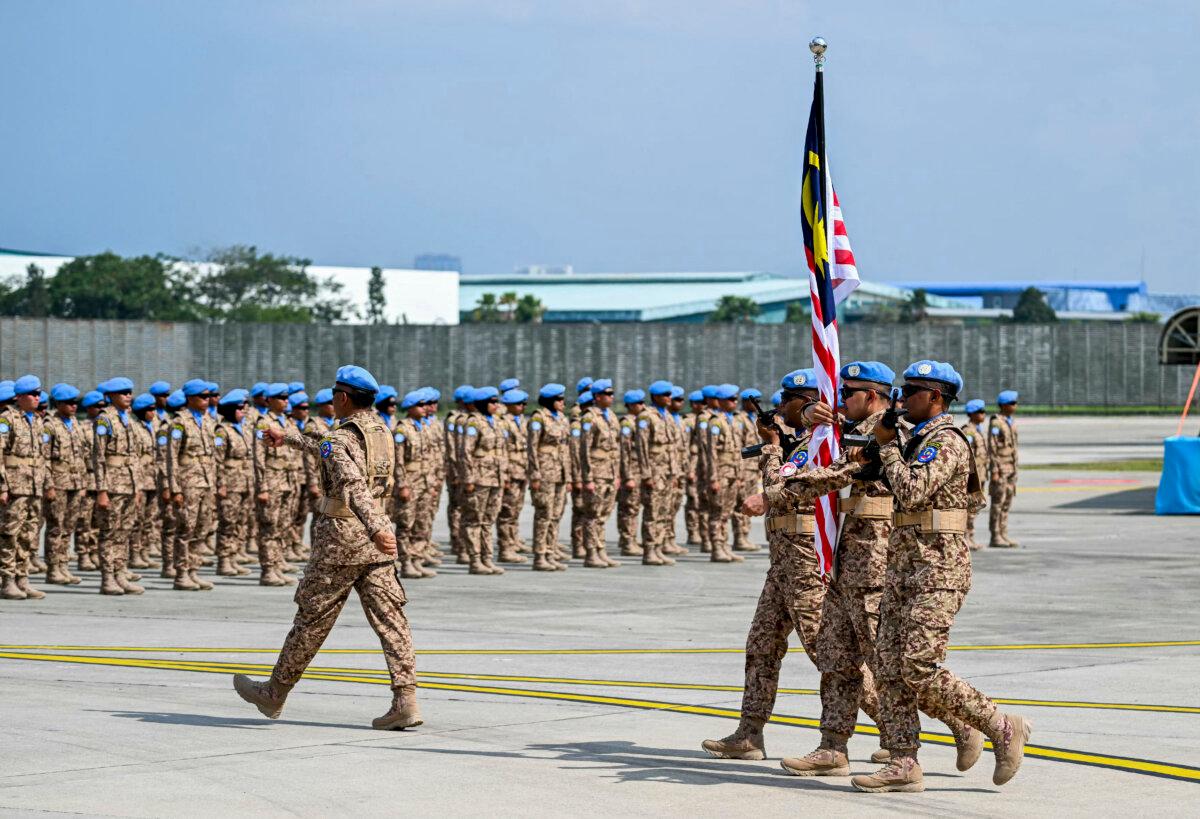 Malaysian Armed Forces escort a national flag during a dispatching ceremony for the first batch of the country's troops bound for Lebanon on Nov. 6, 2024. (Mohd Rasfan/AFP via Getty Images)