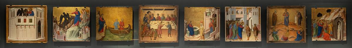 Duccio’s eight panels paintings of the Life of Christ, from the back predella of “Maestà,” at “Siena: The Rise of Painting, 1300–1350” by Eileen Travell. The bottom row of eight narrative paintings includes (L–R) “Temptation on the Temple,” “The Temptation of Christ on the Mountain,” “The Calling of the Apostles Peter and Andrew,” “The Wedding at Cana,” “Christ and the Samaritan Woman,” “The Healing of the Man Born Blind,” “The Transfiguration,” and “The Raising of Lazarus.” (The Metropolitan Museum of Art)