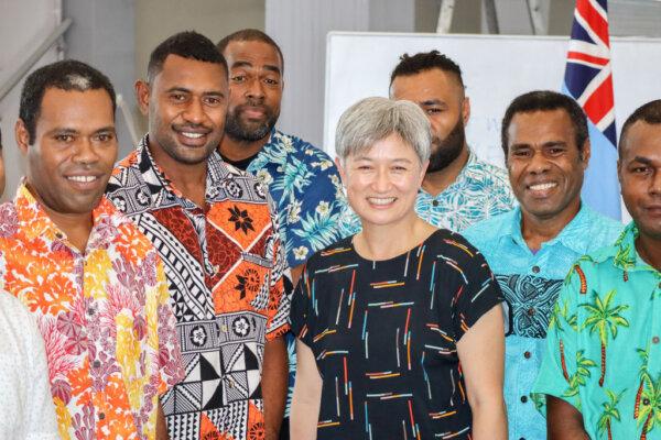 Australian Foreign Minister Penny Wong poses with a group of people who were leaving Fiji to work in Australia under the Pacific Australian Labour Mobility (PALM) Scheme in Suva, Fiji, on May 27, 2022. (Pita Simpson/Getty Images)