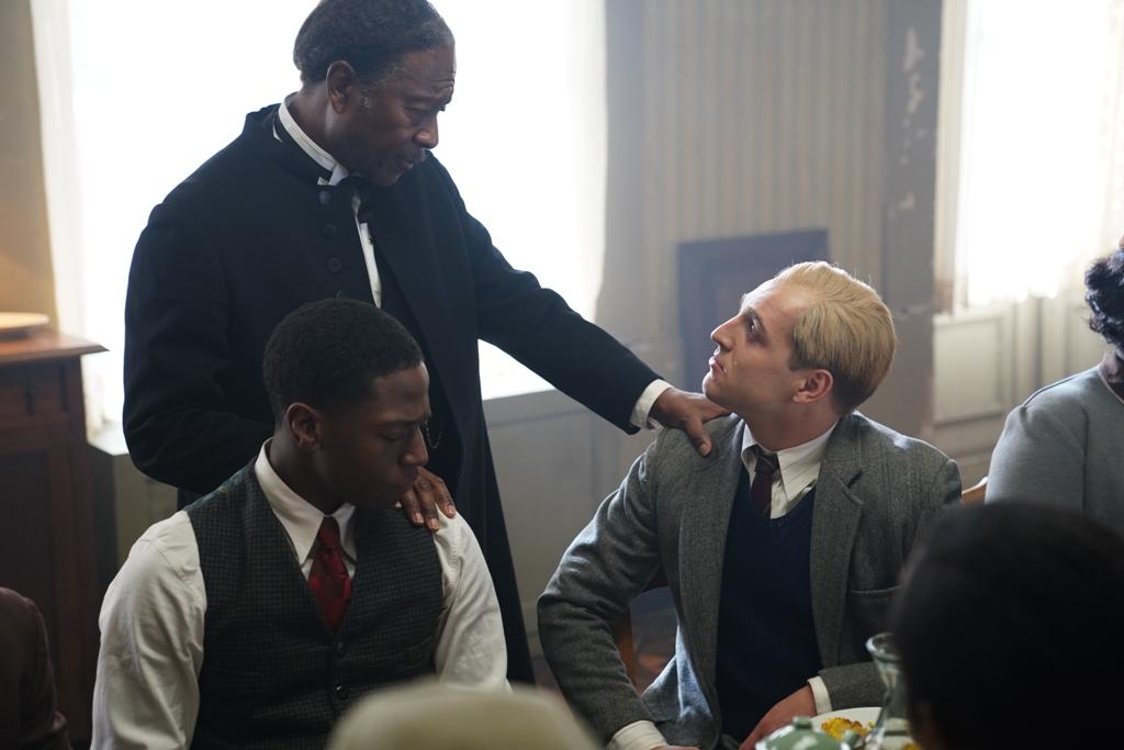 (L–R) Adam Clayton Powell Sr. (Clarke Peters, standing), Frank Fisher (David Jonsson), and Dietrich Bonhoeffer (Jonas Dassler), in “Bonhoeffer: Pastor. Spy. Assassin.” (Angel Studios)