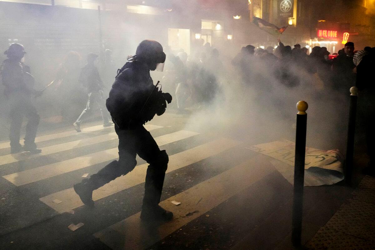Tear gas rises as protesters clash with members of the French National Gendarmerie during a rally organized by political parties against the "Israel is Forever" gala in Paris, on Nov. 13, 2024. (Dimitar Dilkoff/AFP via Getty Images)