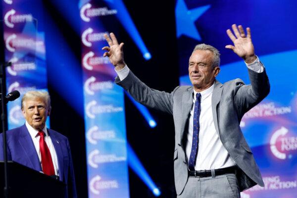 Then Republican presidential nominee, former U.S. President Donald Trump, welcomes Robert F. Kennedy Jr. to the stage at a Turning Point Action campaign rally at the Gas South Arena in Duluth, Ga., on Oct. 23, 2024. (Anna Moneymaker/Getty Images)