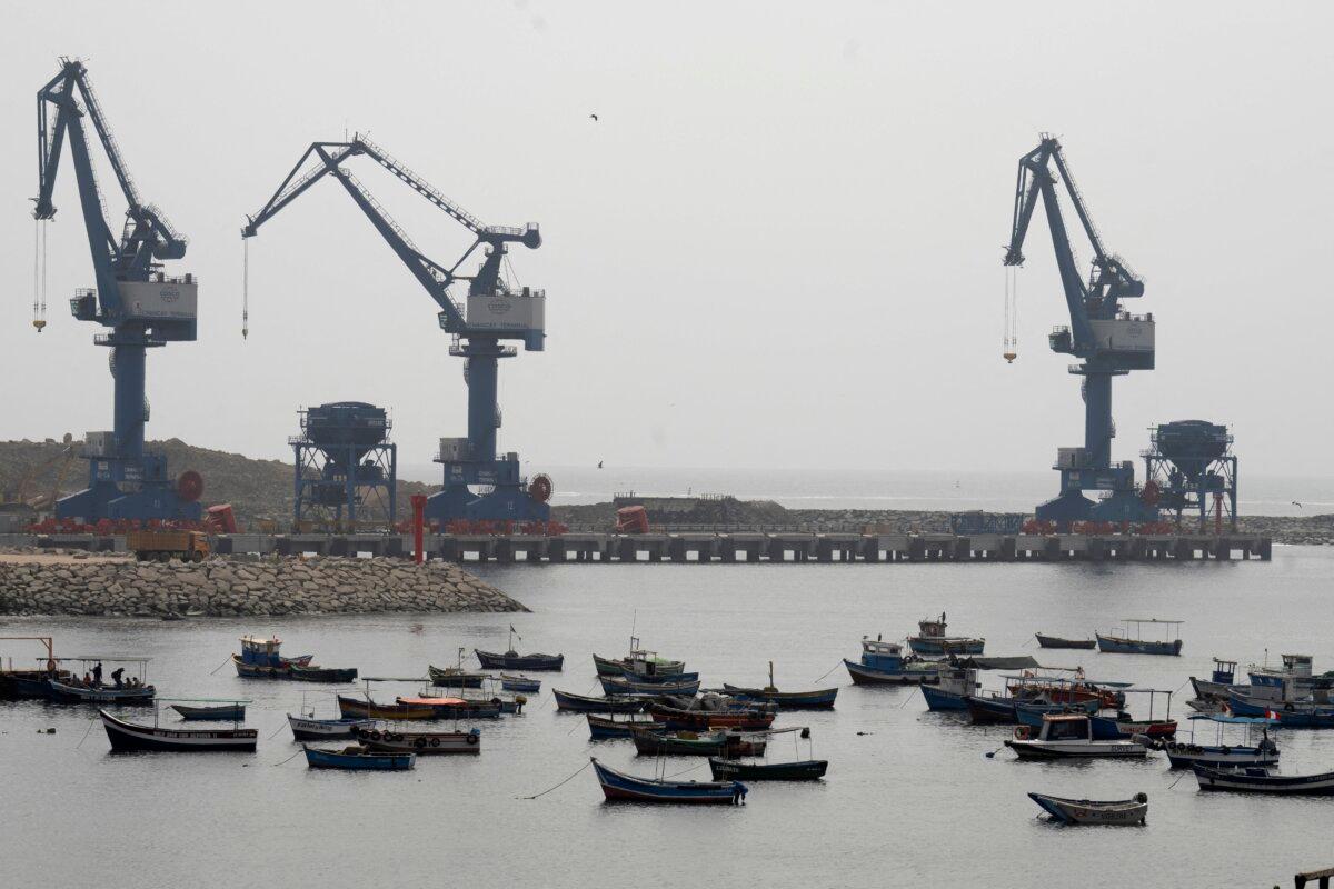 View of a traditional fishing boat buried in the town's harbor "Megaport" On October 29, 2024, a crane in the north background of Lima, the capital of Peru (Cris Bouroncle/AFP via Getty Images)