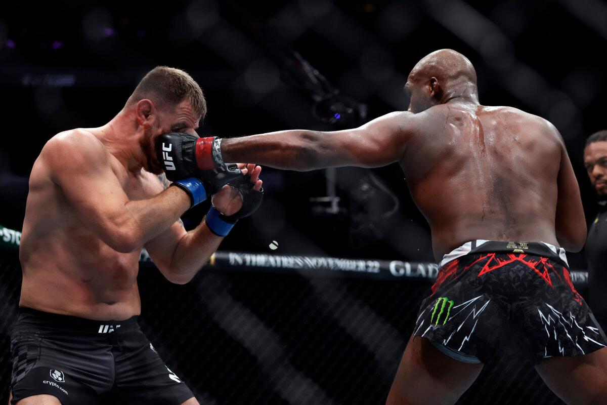 Jon Jones (R) punches Stipe Miocic in a UFC 309 mixed martial arts heavyweight title bout in New York early on Nov. 17, 2024. (Adam Hunger/AP Photo)